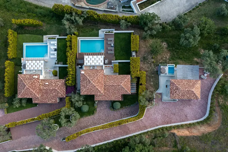 Aerial view of the villas, their pools and gardens on the olive hillside